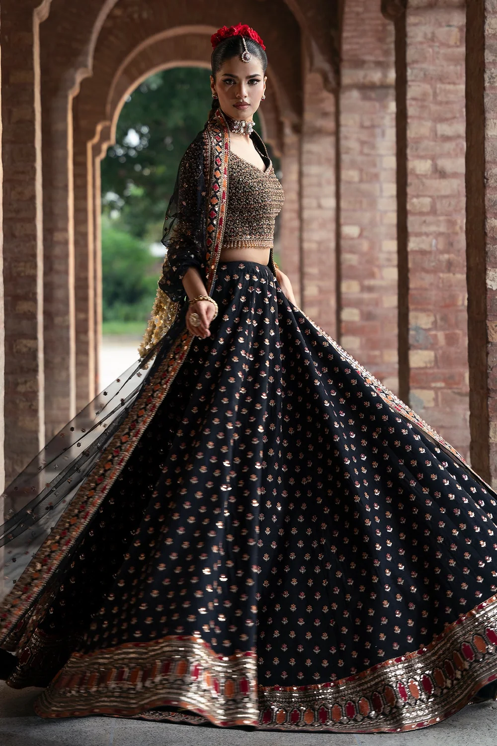 Black formal ensemble with multicoloured embroidery