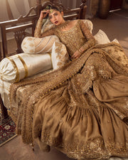 Gold Pakistani bridal outfit with red embroidery