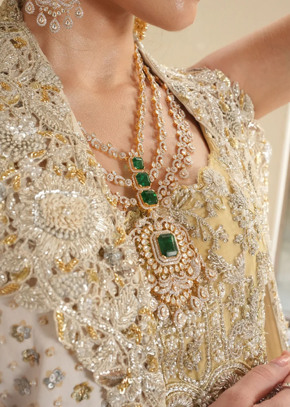 Golden-yellow gown paired with an ivory dupatta featuring an ornate border