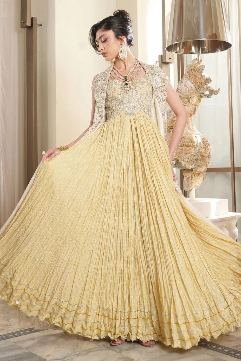 Golden-yellow pleated gown with intricate silver embellishment