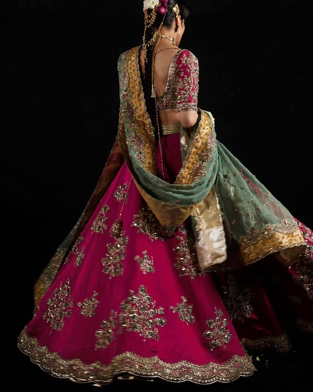 Laal bridal outfit featuring gold embroidery and ornate borders
