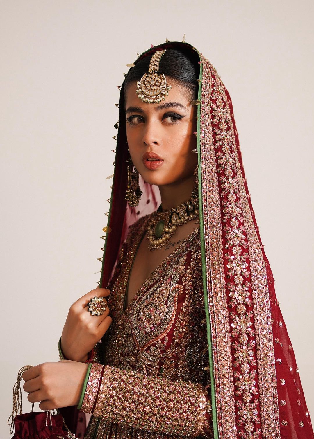 Luxury emerald green embroidered bridal ensemble with embellished dupatta
