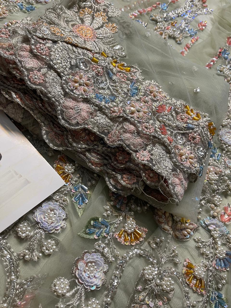 Rose pink and yellow detailing on pistachio green formal wear