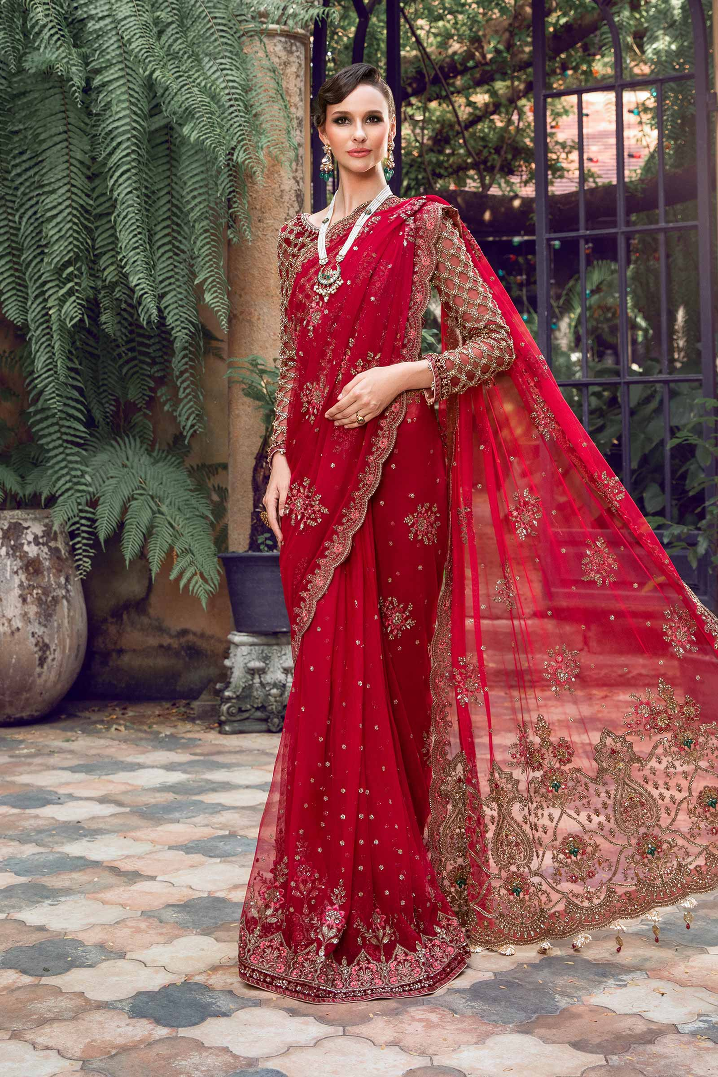 Red Pakistani wedding outfit with detailed embroidery