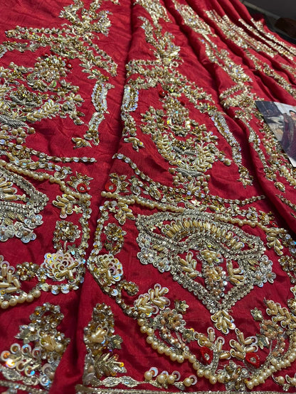 Deep red Pakistani bridal lehenga with gold handwork