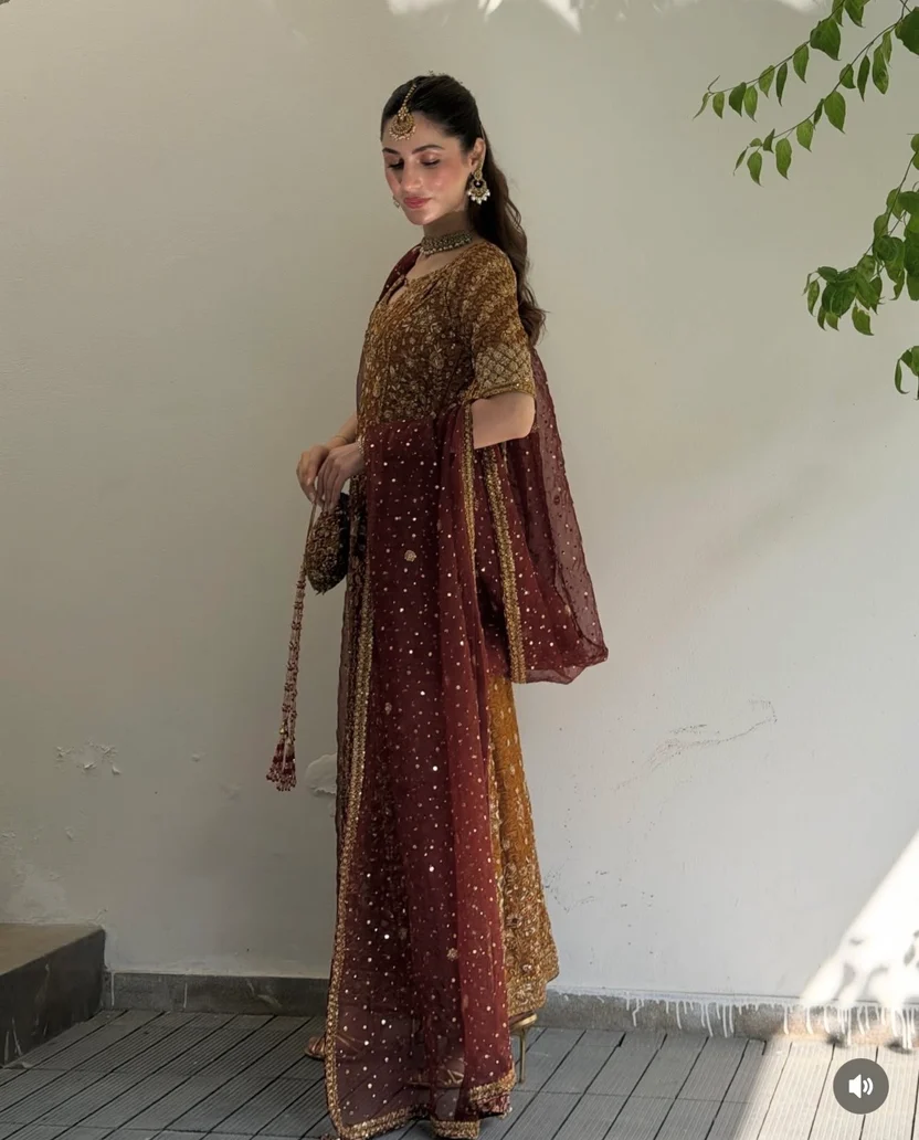 Rust and burgundy wedding outfit paired with an embellished potli bag