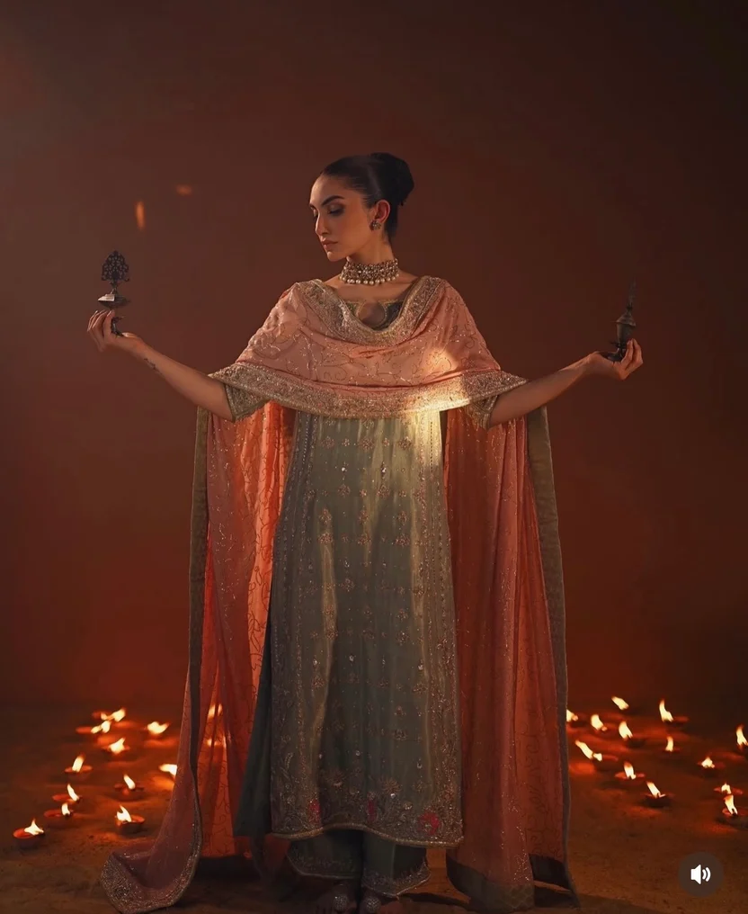 Sage-green sleeves with dense embroidery and ornate borders