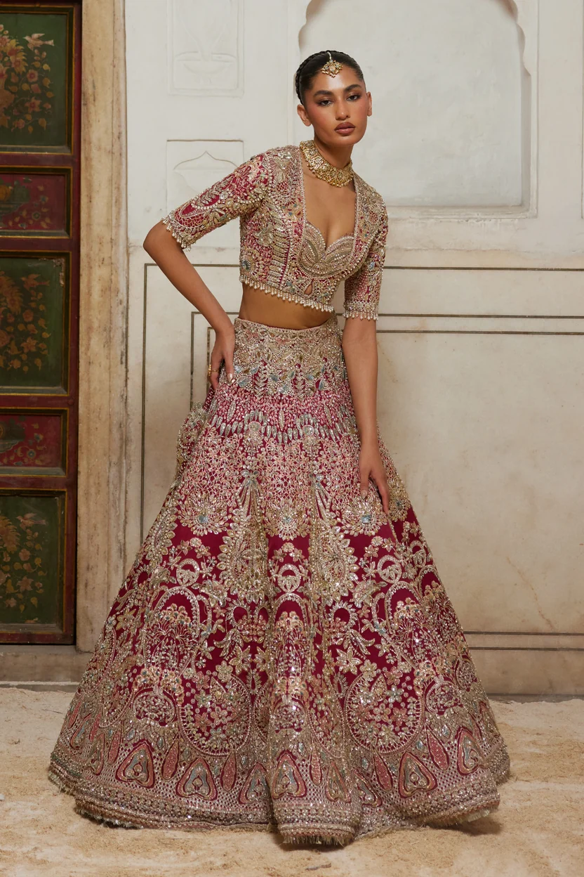 Deep red flared lehenga with dense traditional embroidered panels