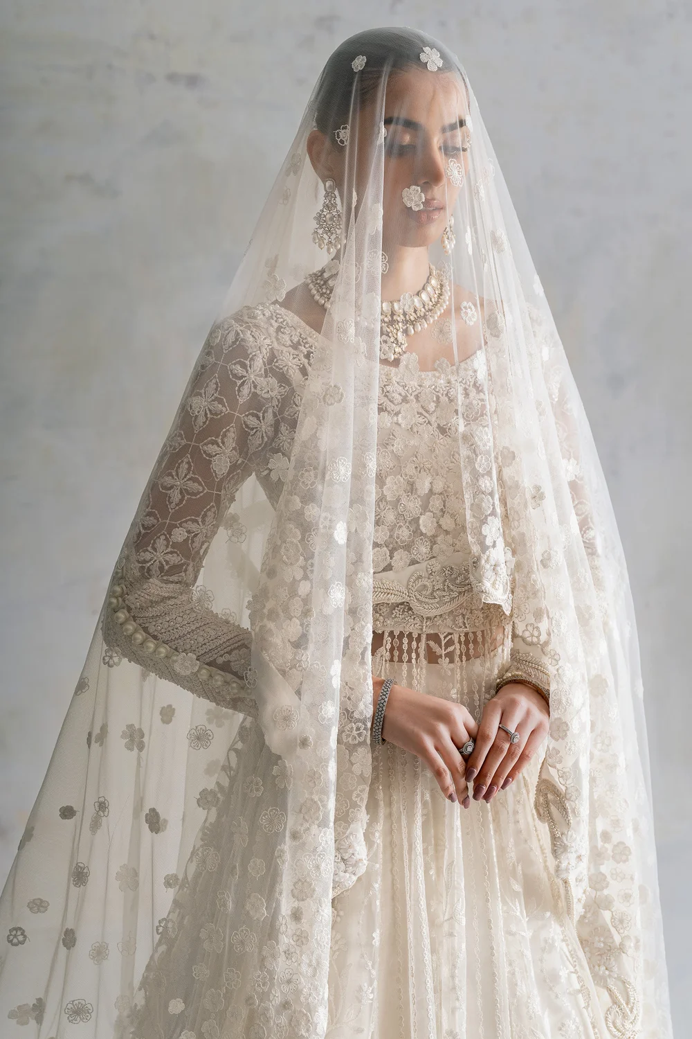 White formal dress with intricate bodice and sleeve work